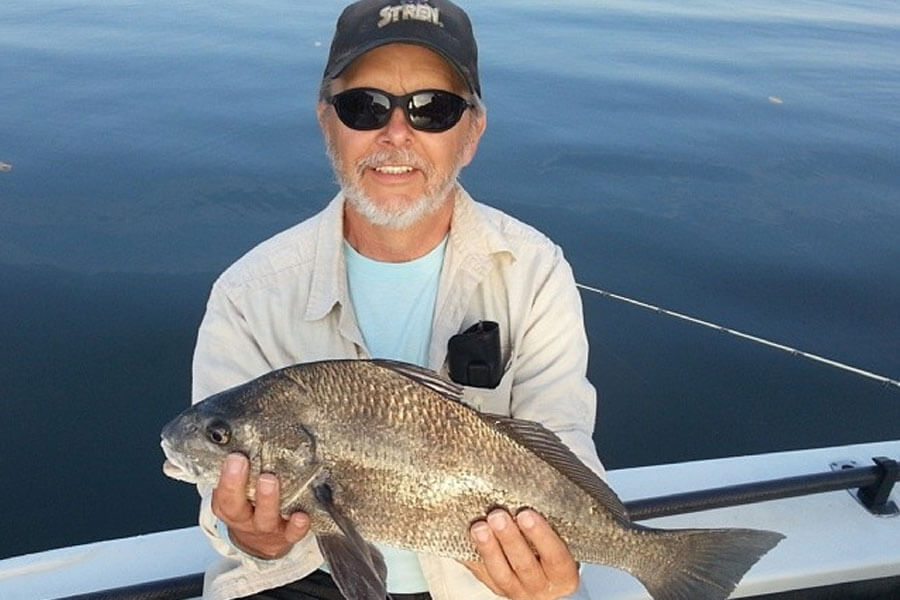 Man holding black drum at the Inshore Fishing Charter in Cocoa Beach