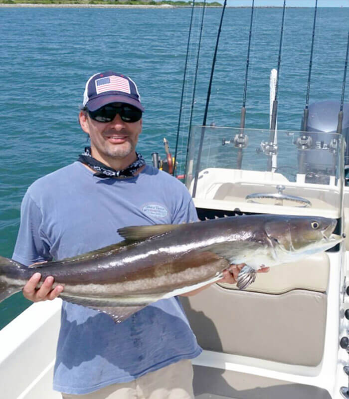 Man holding Cobiaa at the Deep Sea Fishing Charter in Cocoa Beach
