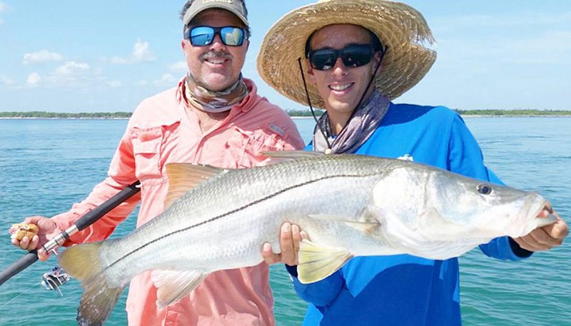 Men holding snook at the Orlando Fishing Charter