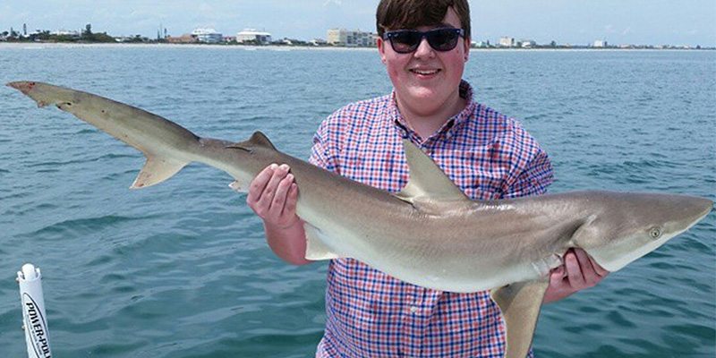 Boy Holding a Shark at the Orlando Fishing Charter