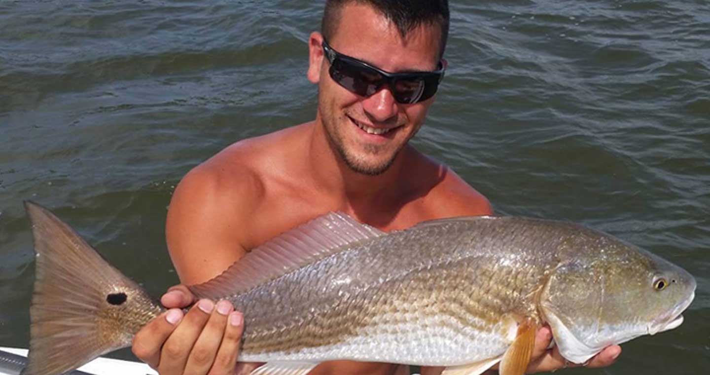 Man holding redfish at the Inshore Fishing Charter in Cape Canaveral