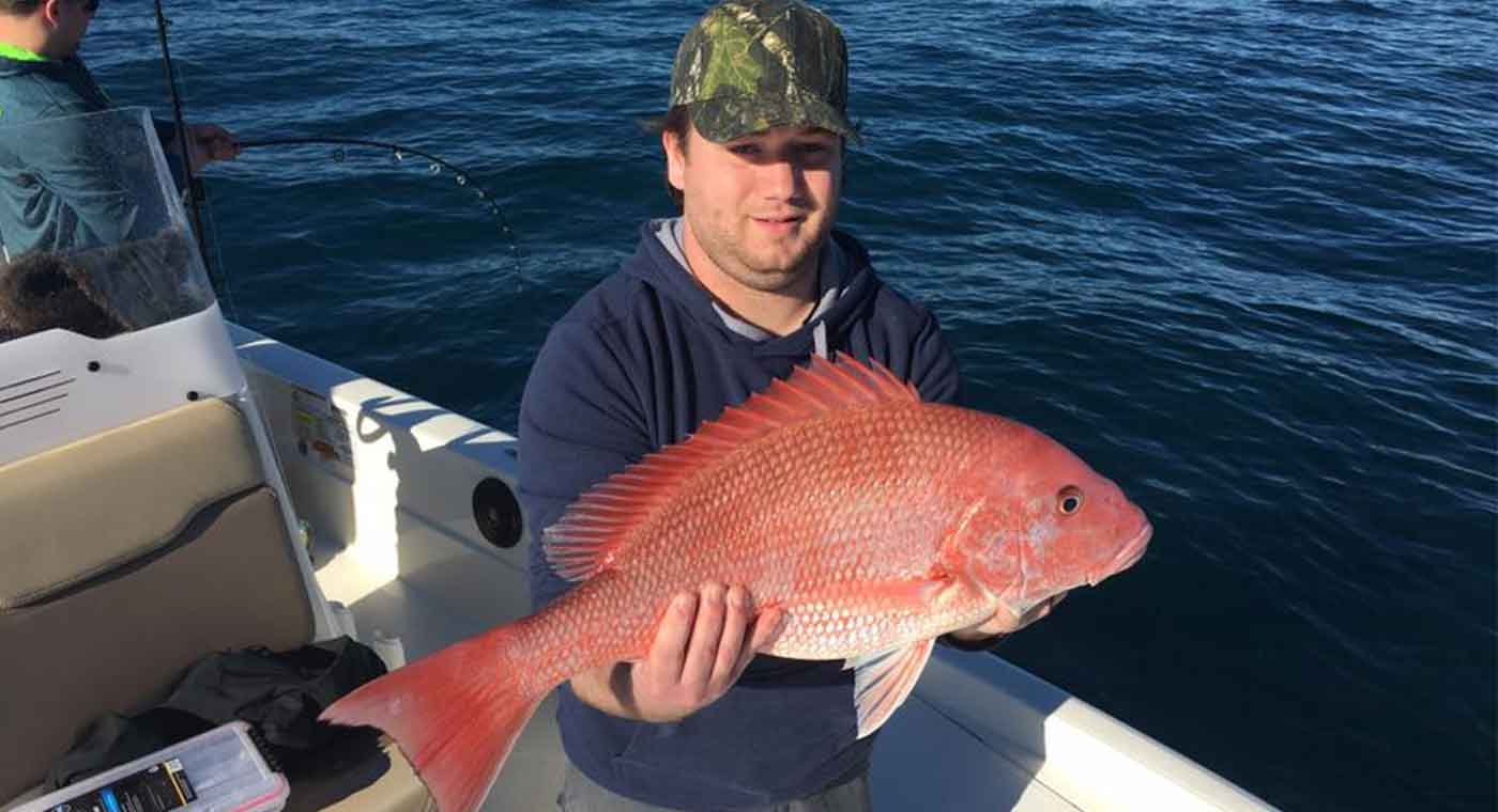 Man Holding Red Snapper at the Cape Canaveral Red Snapper Fishing Charter