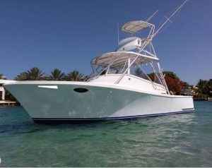 Central Florida deep sea fishing large white boat on green blue water