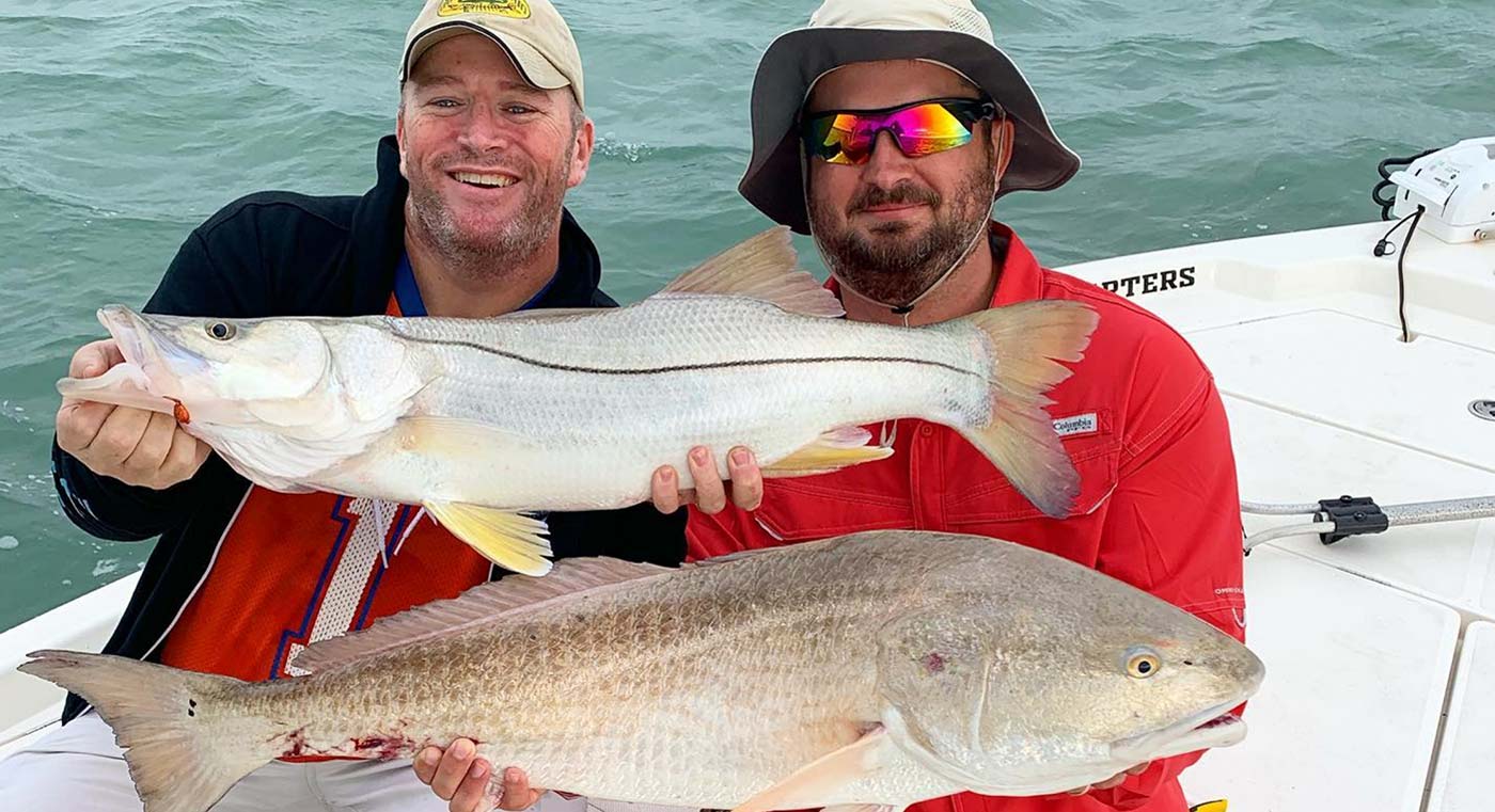 Men holding snook caught on Sebastian Inlet fishing charter