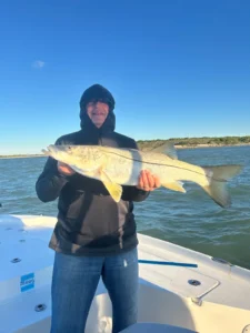 Angler holding a snook caught on a fishing charter in Port Canaveral, Florida.