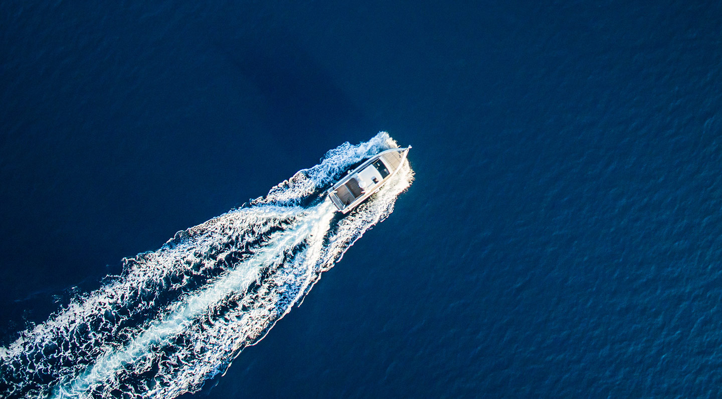 Aerial view of a charter boat running offshore from Cape Canaveral in deep blue water