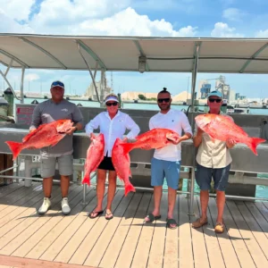 Anglers holding red snapper at Port Canaveral during the Atlantic red snapper season near Cocoa Beach, Florida.
