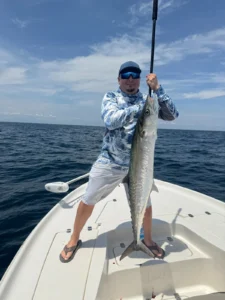 Angler holding a large kingfish during a Cape Canaveral offshore fishing trip